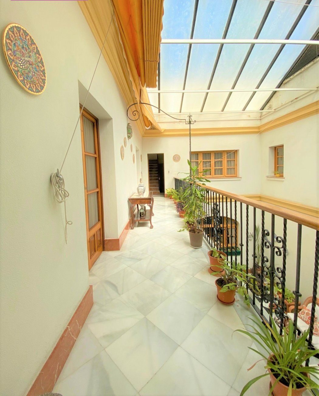 Looking upward from the upper gallery to the glazed iron-and-glass skylight.